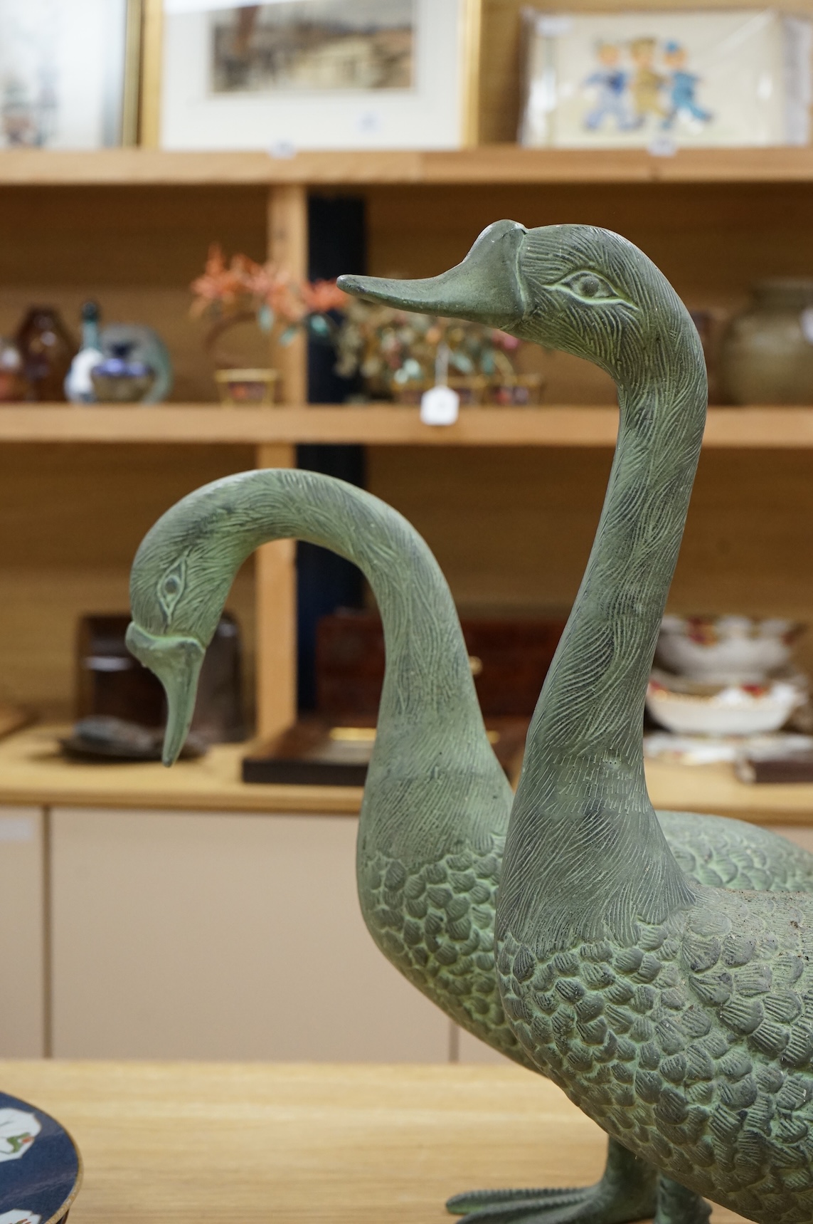 A pair of patinated spelter models of geese, 49cm